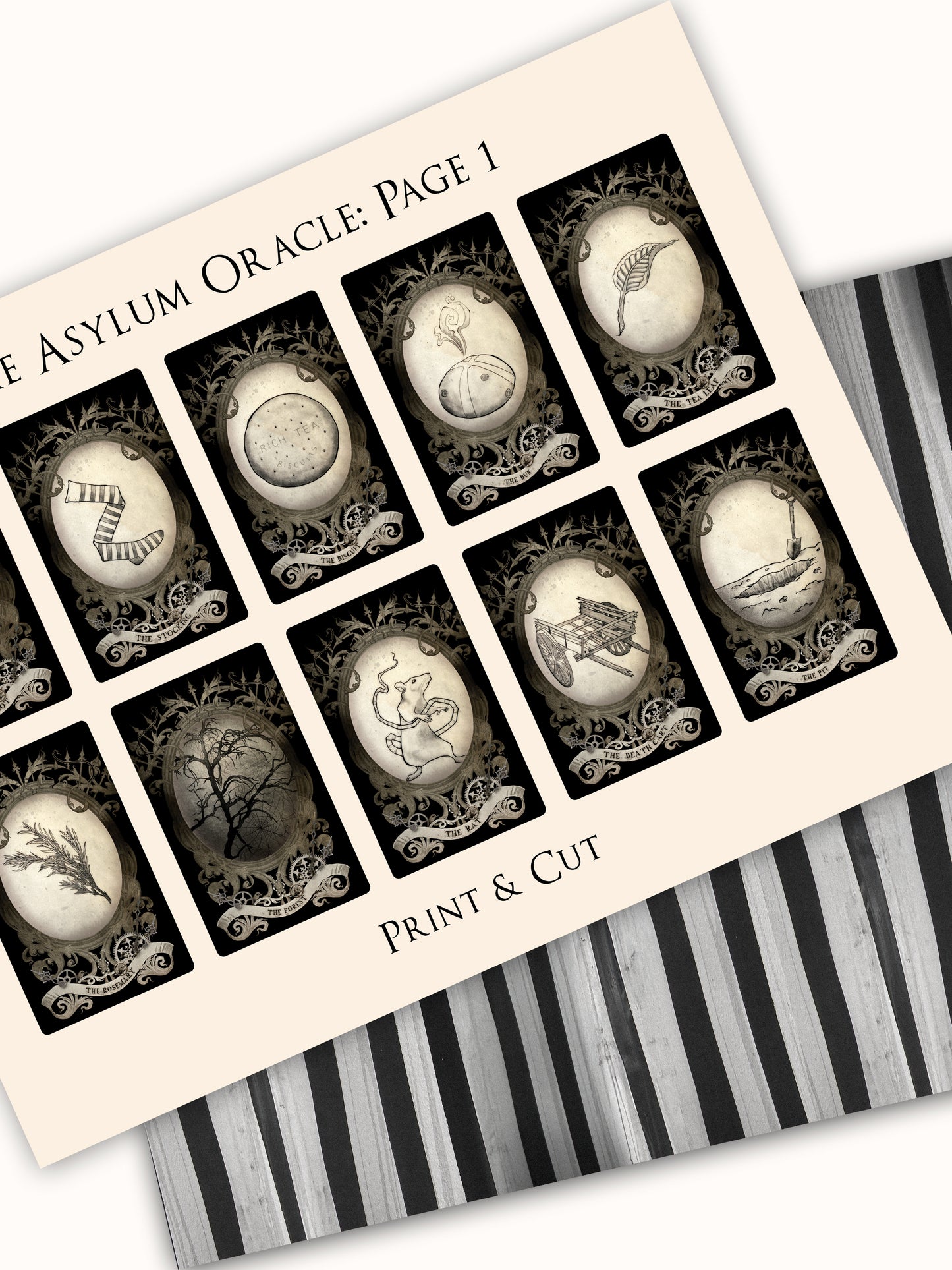 Sheet of black and white oracle cards with decorative frames on a striped background.