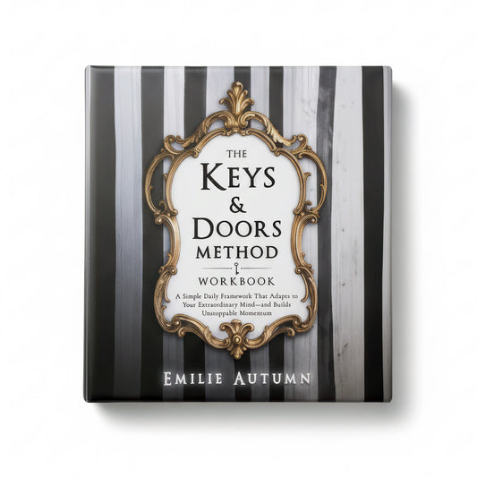 Book titled 'The Keys & Doors Method Workbook' by Emilie Autumn on a black and white striped background