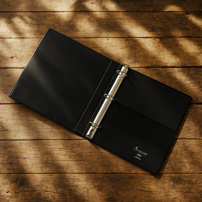 Black binder with a silver ring on a wooden surface